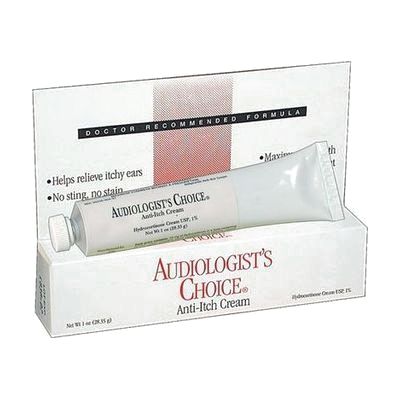 A white cream tube with a red cap, standing beside its white printed box with red cross detailing.