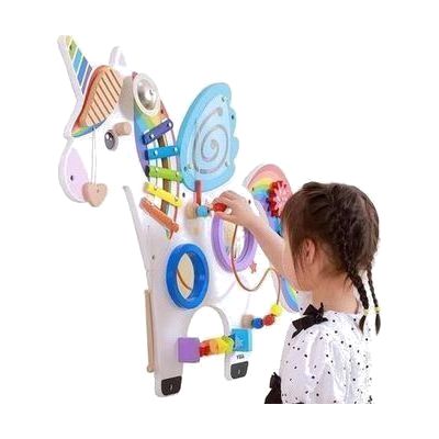 A child looking at and playing with an interactive colorful horse toy.