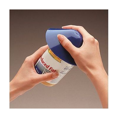 Circular flat non-slip grip pad in bright color, approximately 4 inches across, made of flexible rubber-like Dycem material