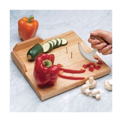 Rectangular light-colored maple wood cutting board with metal spike inserts and raised wooden guards along two edges