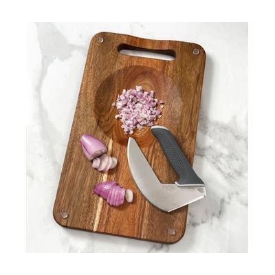 Rectangular bamboo cutting board with an integrated recessed bowl cutout near one end and an ergonomic side handle