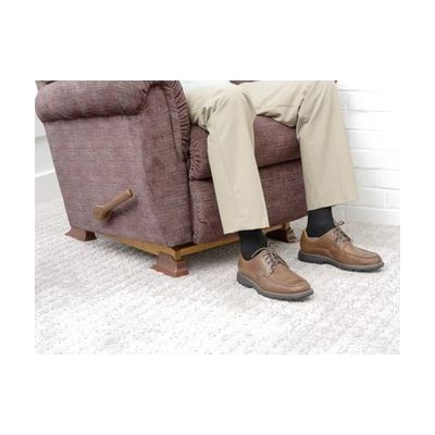 Set of four tan-colored furniture risers with non-slip pads on bottom surface