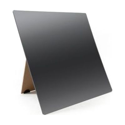 A frameless mirror propped up on its brown stand sitting on a white background.