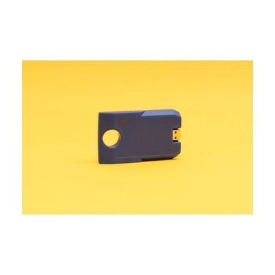 Angled front view of the blue digital talking book cartridge against a yellow background. The cartridge has a circular hole on one end and a USB port on the other, and it reads "4GB."