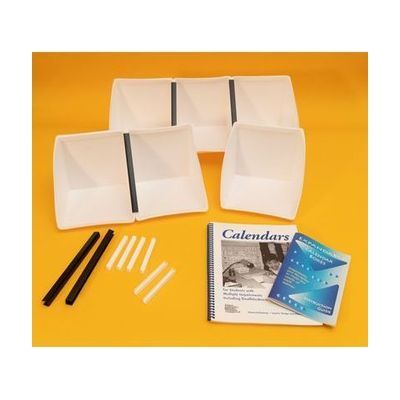 All components of the White Expandable Calendar Boxes kit laid out on a yellow background. Included are six white foam boxes attached to one another with black and white U-channels, two additional large black U-channels, six smaller white U-channels, and the print guidebooks placed in front.