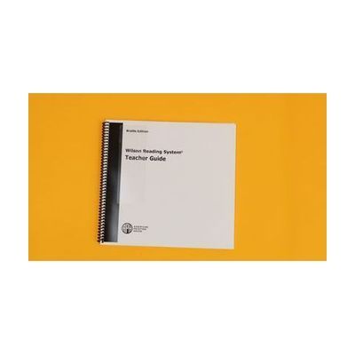 Braille edition of the teacher guide. On the cover, it says "Wilson Reading System. Teacher guide." An APH logo is in the bottom left corner.