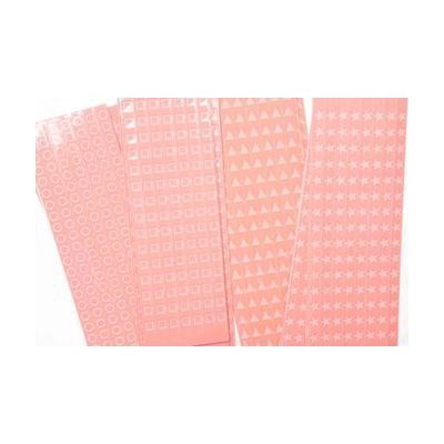 Close up of overlapping perforated shape strips including circles, squares, triangles, and stars.