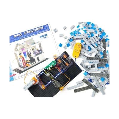 An aerial view of a light-emitting BRIC: Structures project built on a base plate. In the background is the BRIC: Structures box and an assortment of building blocks.