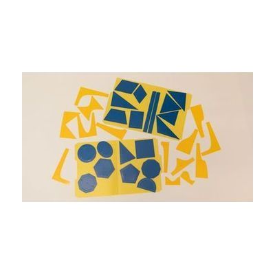 An overhead shot of the Geometric Drawing Stencils attached to a yellow folder with the 3D printed function stencils spread around them. Each shape has an inner stencil and an outer stencil. Shapes include ovals, octagons, circles, triangles, and many more polygons.