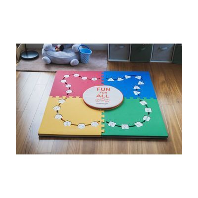 All four pieces of the Reach & Match Light kit assembled in a square on a wooden floor with alphabet tiles inserted into the cut-outs. The carrying case sits in the center and reads "FUN for ALL" with the Reach & Match logo beneath.