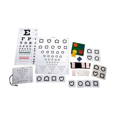 A variety of acuity measurement charts, symbol cards, and a puzzle board laid out on a white background.