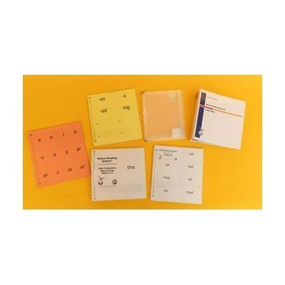 The card set components laid out on a yellow background, including a three-ring binder, binder inserts, and four sets of cards in a variety of colors with print and braille labels.