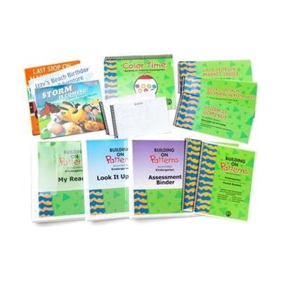 The components of the Building On Patterns Kindergarten, Second Edition Student Kit on a white background, including a stack of print storybooks, their BOP braille companions, a coloring book, a parent booklet, and three binders.