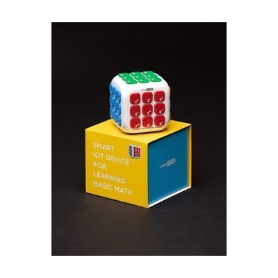 Creacube with the red buttons facing forward sitting on top of the yellow and blue box.