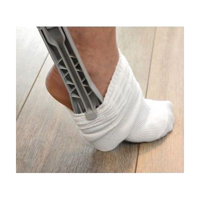 Plastic sock dressing aid with two long angled handles and a frame for loading socks, shown in light grey