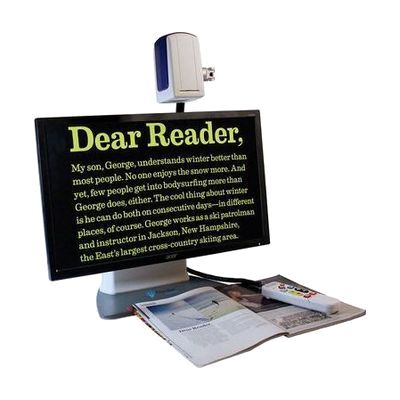 Desktop video magnifier with integrated camera mounted on articulating arm above a monitor display