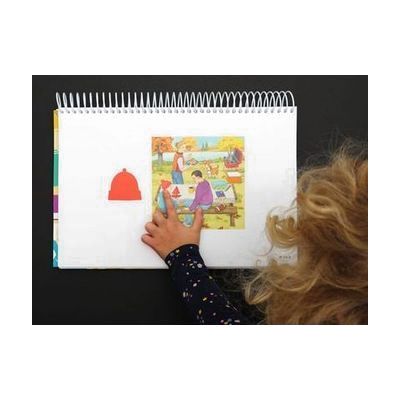 kid with hand on matching skills page