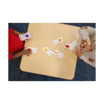 Colorful tactile puzzle pieces in various geometric shapes with raised braille labels, stored in a fabric pouch
