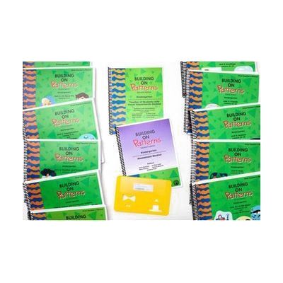 The components of the Building On Patterns Kindergarten, Second Edition Print Teacher's Kit on a white background. On either side are the green teacher's manuals laid out in lines, and in the middle are the teacher's booklet, the assessment booklet, and a stencil.