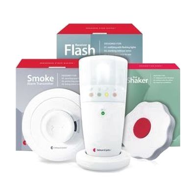 White smoke detector unit paired with a rectangular white flash receiver and a flat oval bed shaker pad