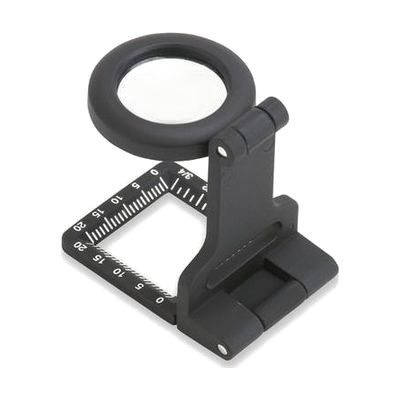 Small metal fold-out loupe magnifier with round 20mm glass lens and ruler markings on frame, shown open
