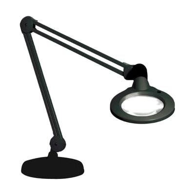 Black desk lamp with large circular magnifying lens mounted on a long articulating spring arm above a weighted round base