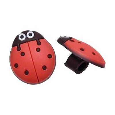 Small red and black ladybug-shaped rubber charm designed to slide onto hearing aid tubing