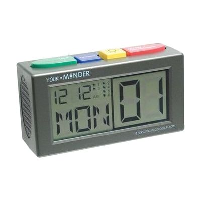 A grey talking alarm clock with four colored top buttons and a digital screen showing time, day, and date.