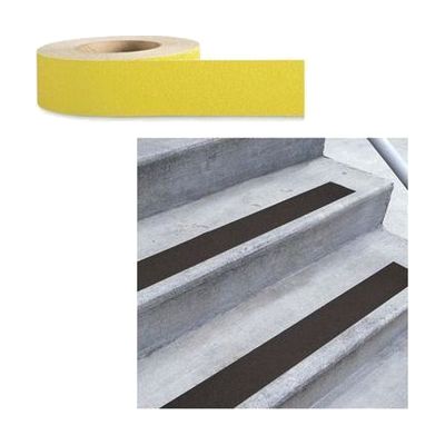 A roll of textured yellow tape shown beside concrete steps with matching strips applied to their edges.