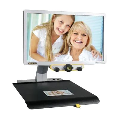 A desktop video magnifier with a widescreen monitor above a black reading platform.